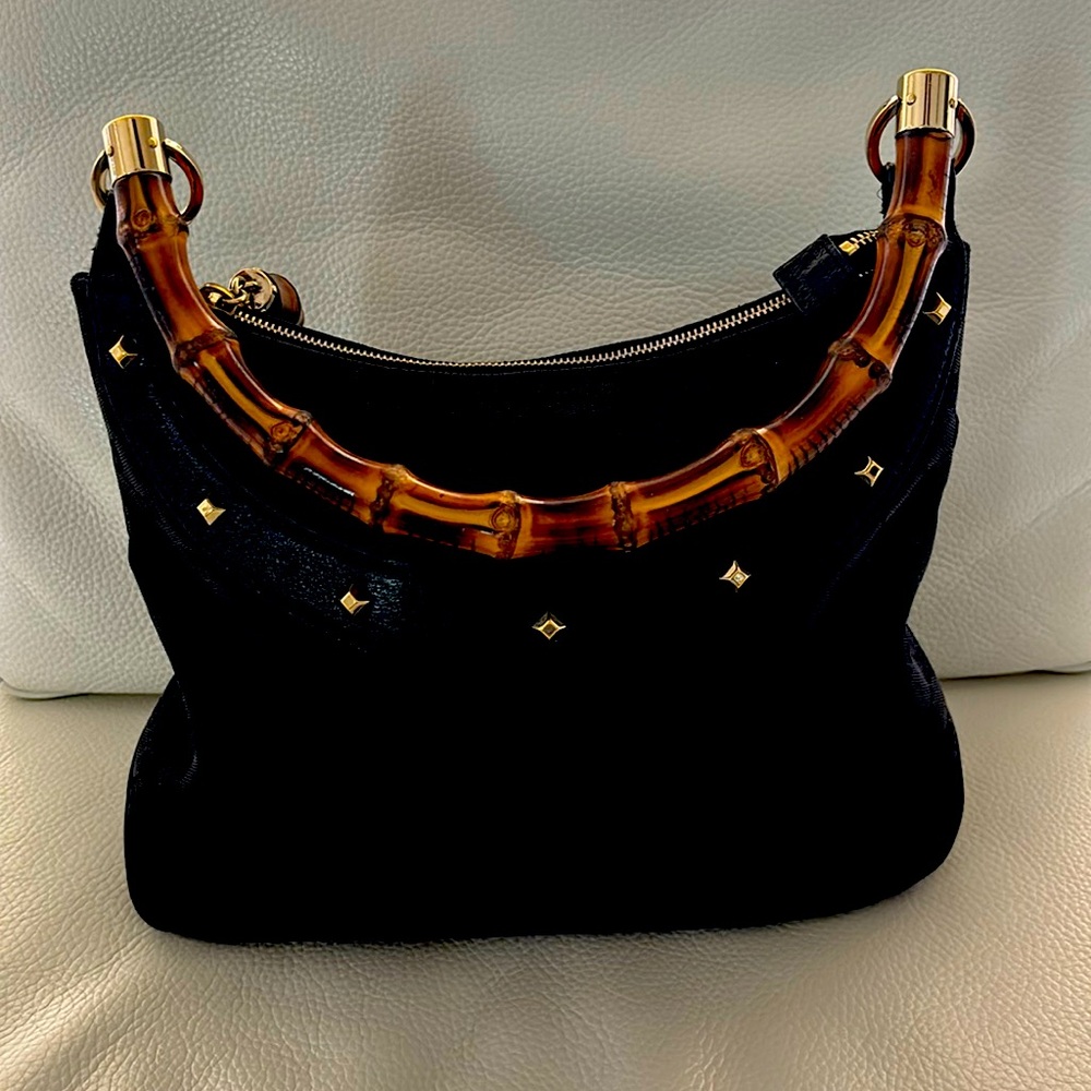 Genuine Gucci canvas with bamboo handle and leather trim.